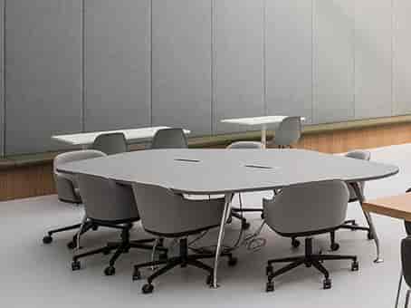 Modern meeting space with oval table, ideal for presentations and collaboration.