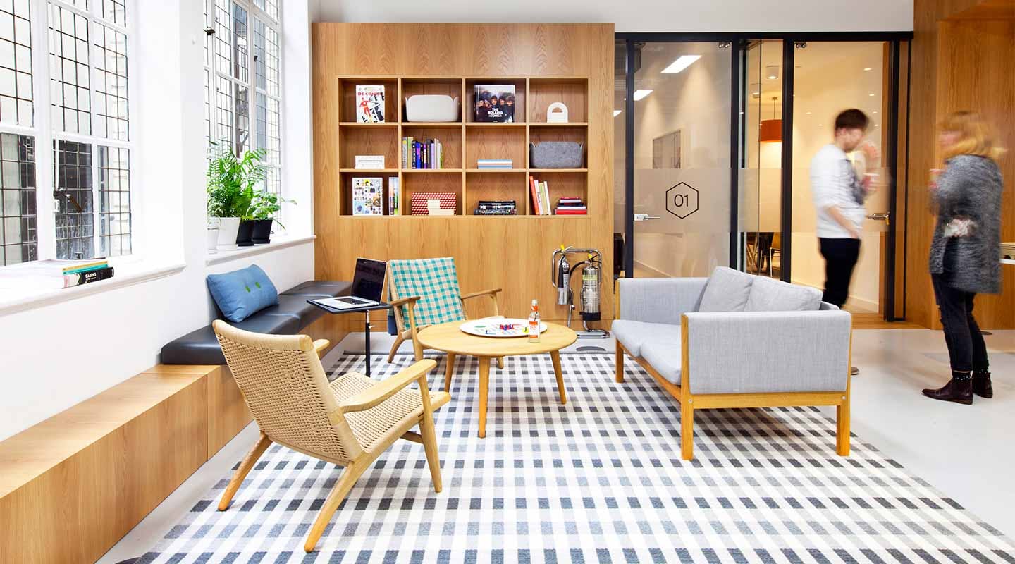 Modern lounge area with warm wood tones for networking and informal meetings.