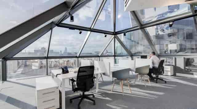 Modern meeting room with glass windows, ideal for corporate events and workshops.