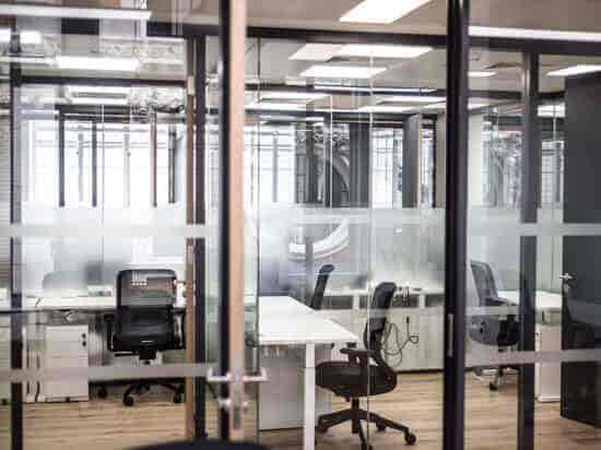 Modern meeting room with glass partitions for collaborative team sessions at Spaces Oxford Circus.