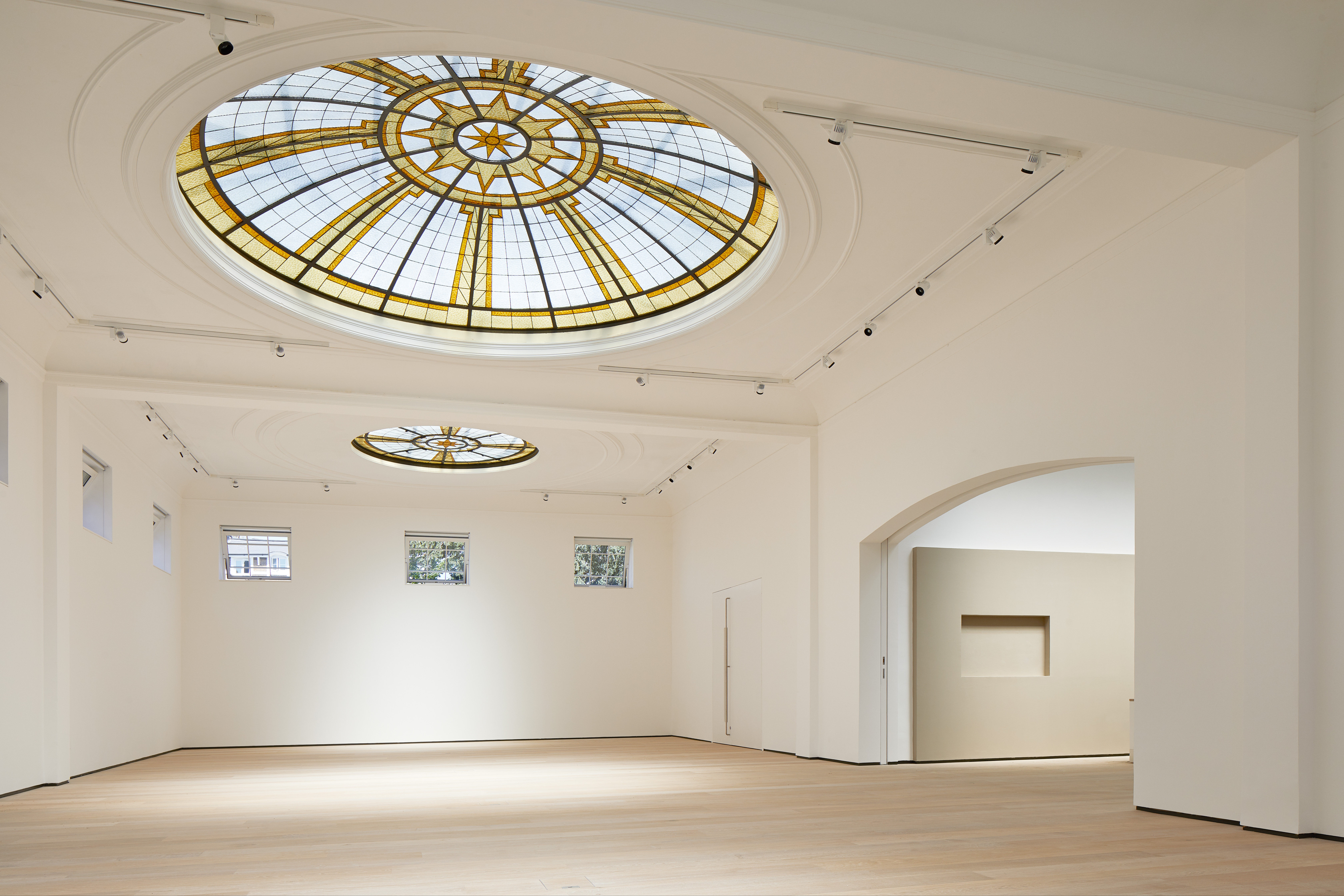 Spacious Pitzhanger Manor gallery with elegant stained glass ceiling for events.