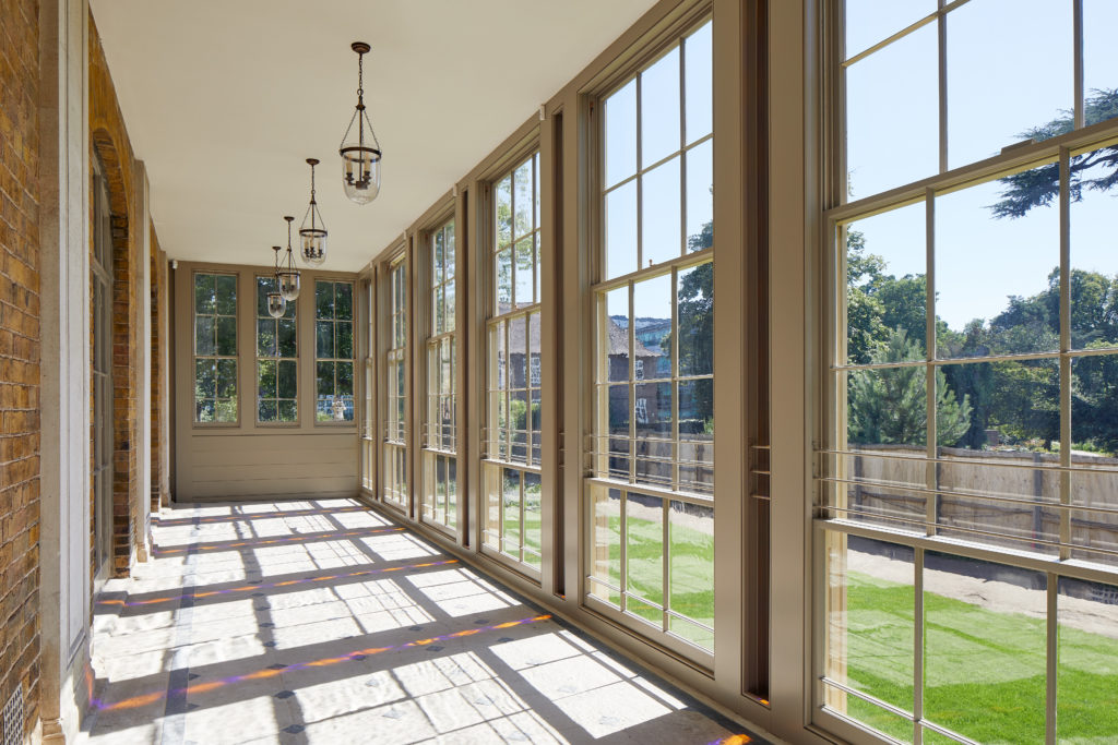 Soane Suite corridor with large windows, ideal for creative networking events. - Banner