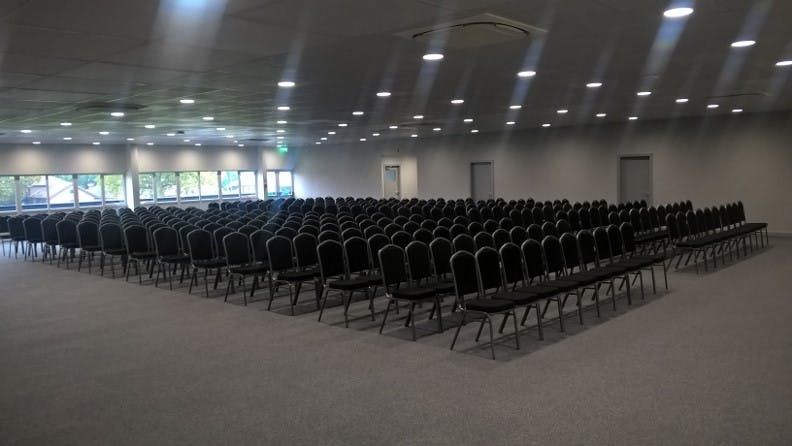 Spacious conference venue with black chairs for engaging seminars at NAEC Stoneleigh.