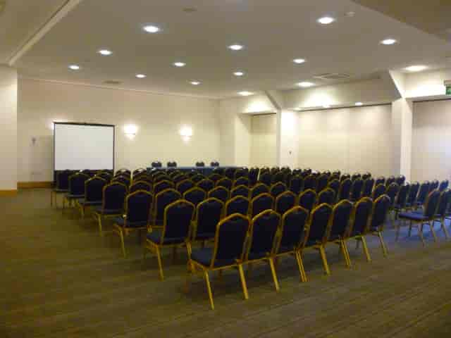 Conference room with organized chairs and screen at NAEC Stoneleigh for seminars.