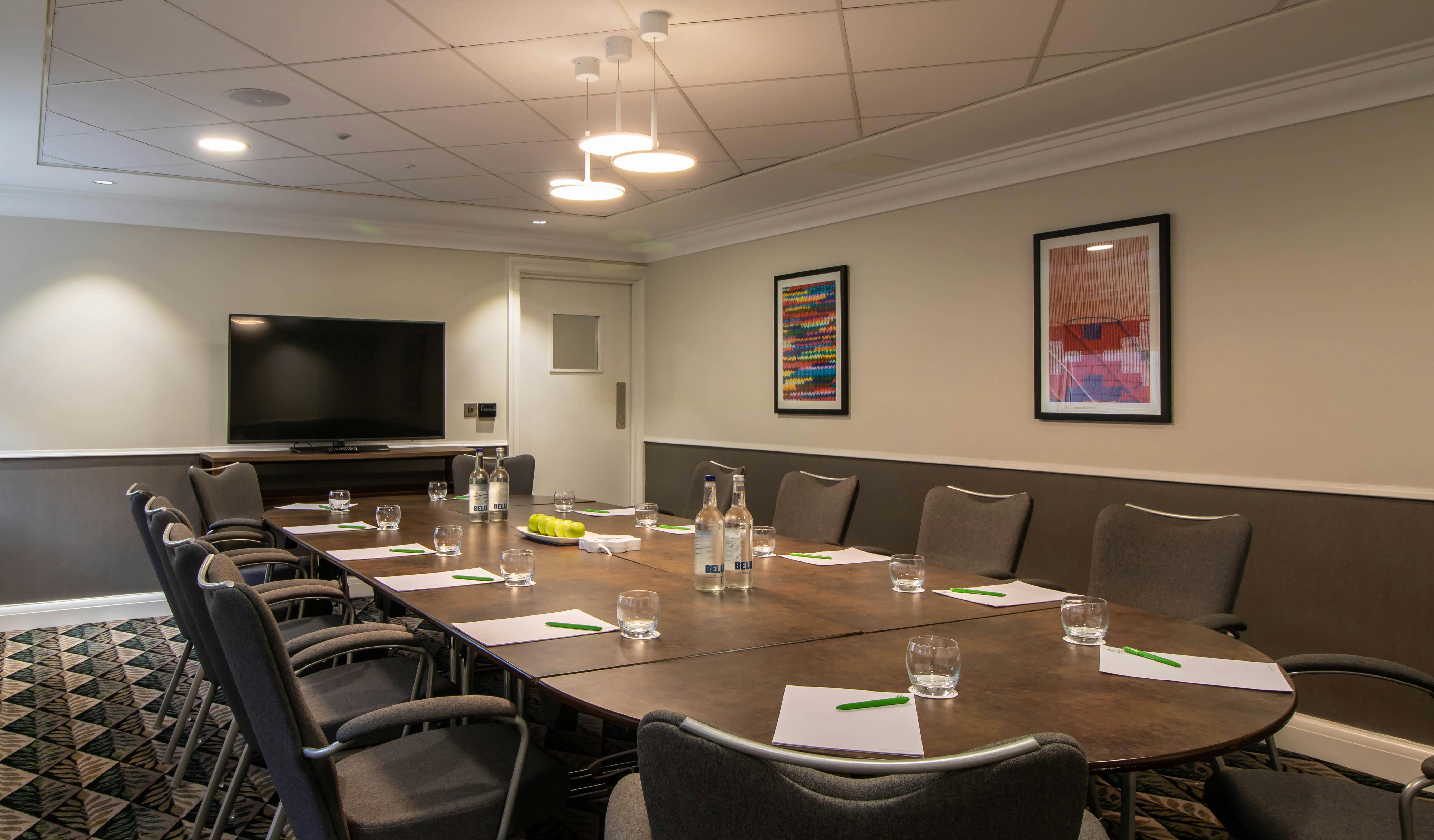 Leicester Suite meeting room with oval table, ideal for professional gatherings and presentations.