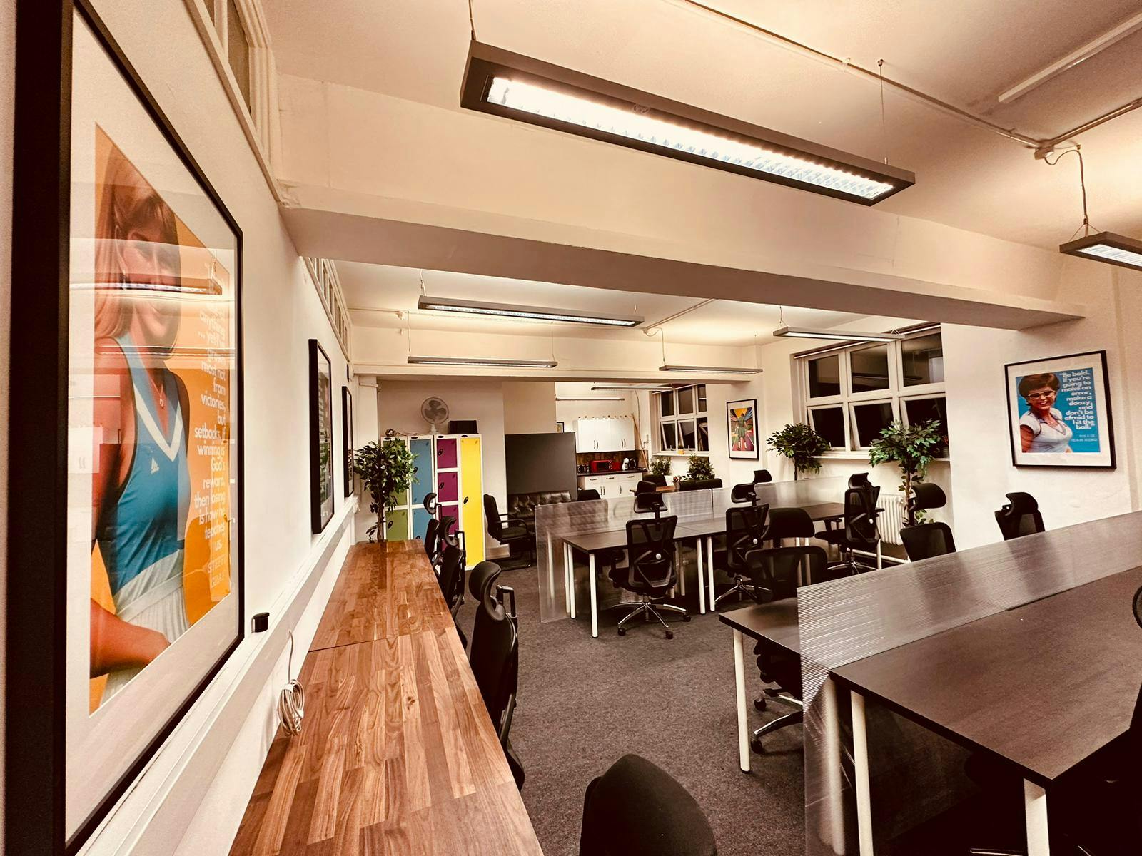 Modern meeting space in Wimbletech with large tables and vibrant artwork for workshops.