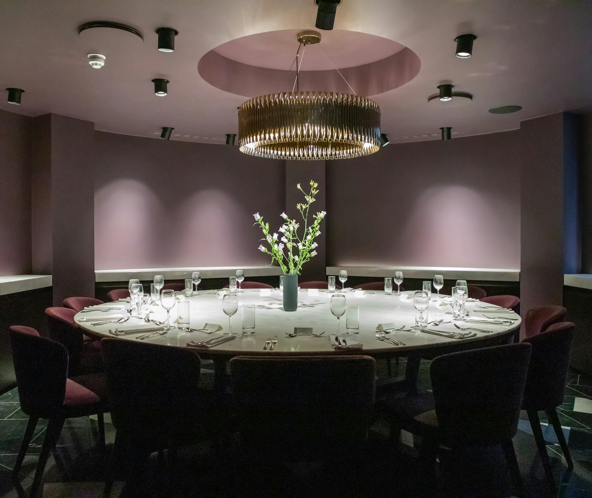 Sophisticated private dining room with circular table for exclusive corporate events.