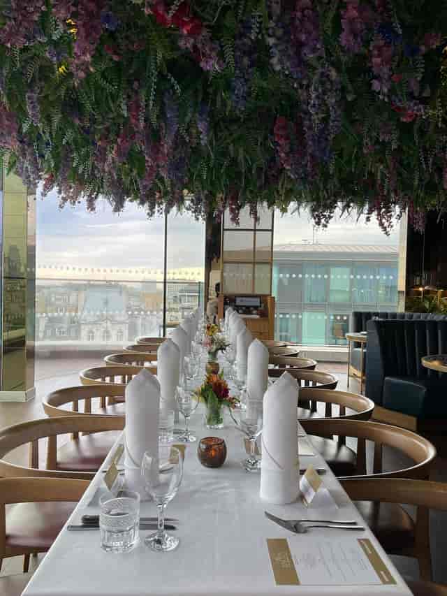 Elegant dining setup with floral centerpieces at LSQRooftop for upscale events.