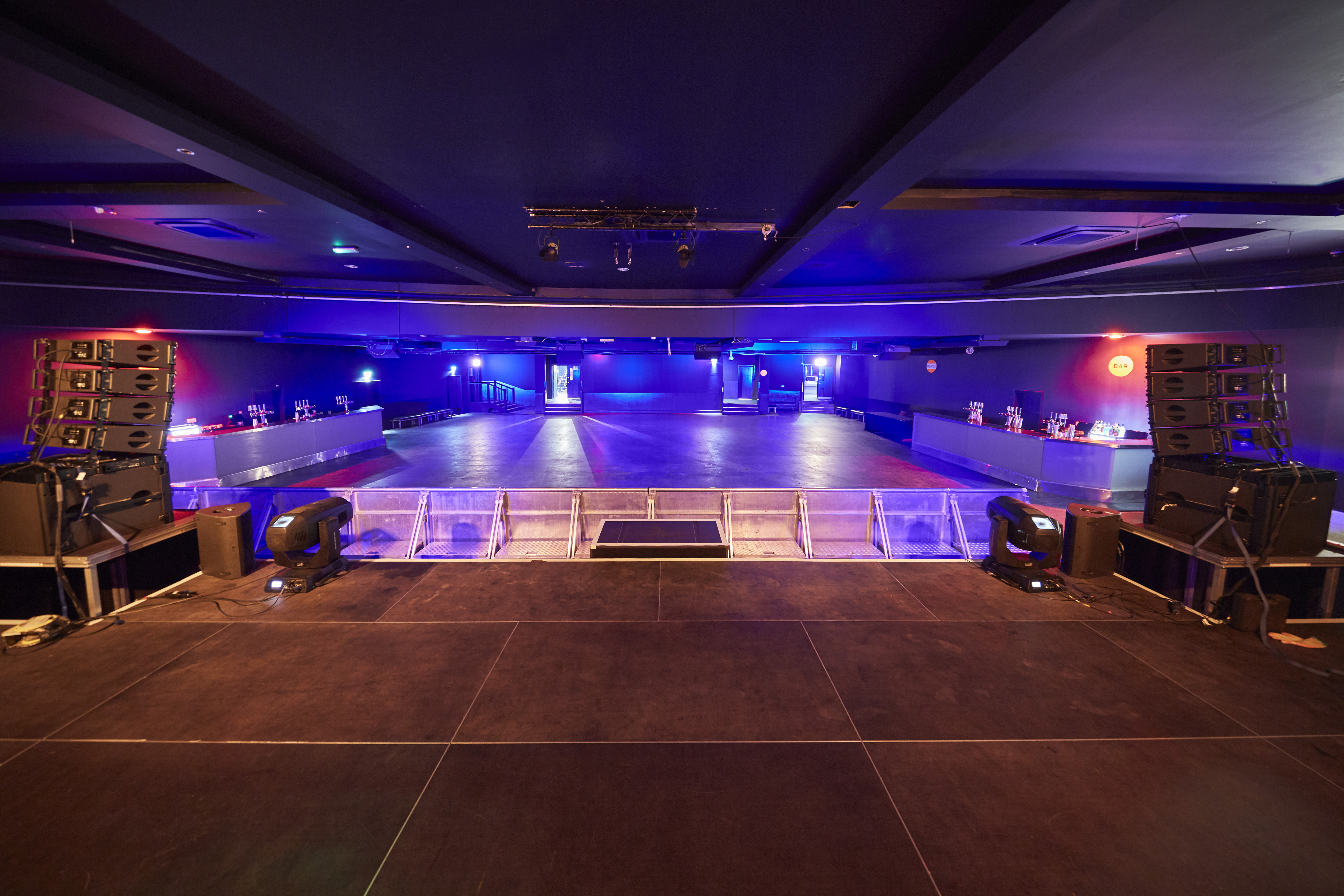 Modern Concert Hall with spacious dance floor for events and live performances. - Banner