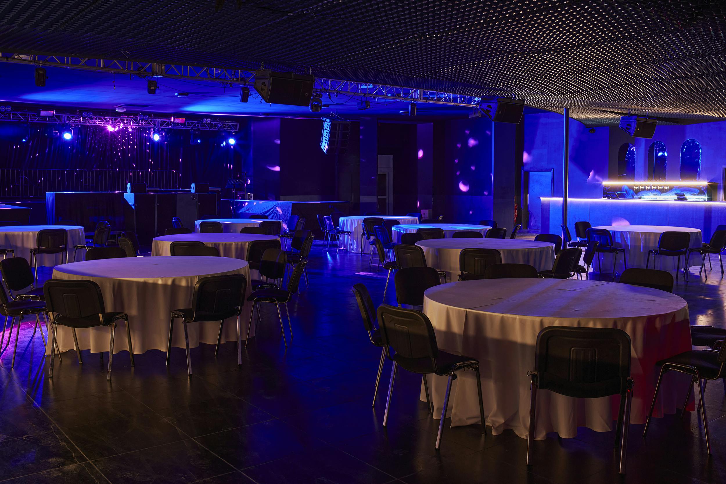 Versatile Concert Hall in EartH with round tables for dining and networking events.