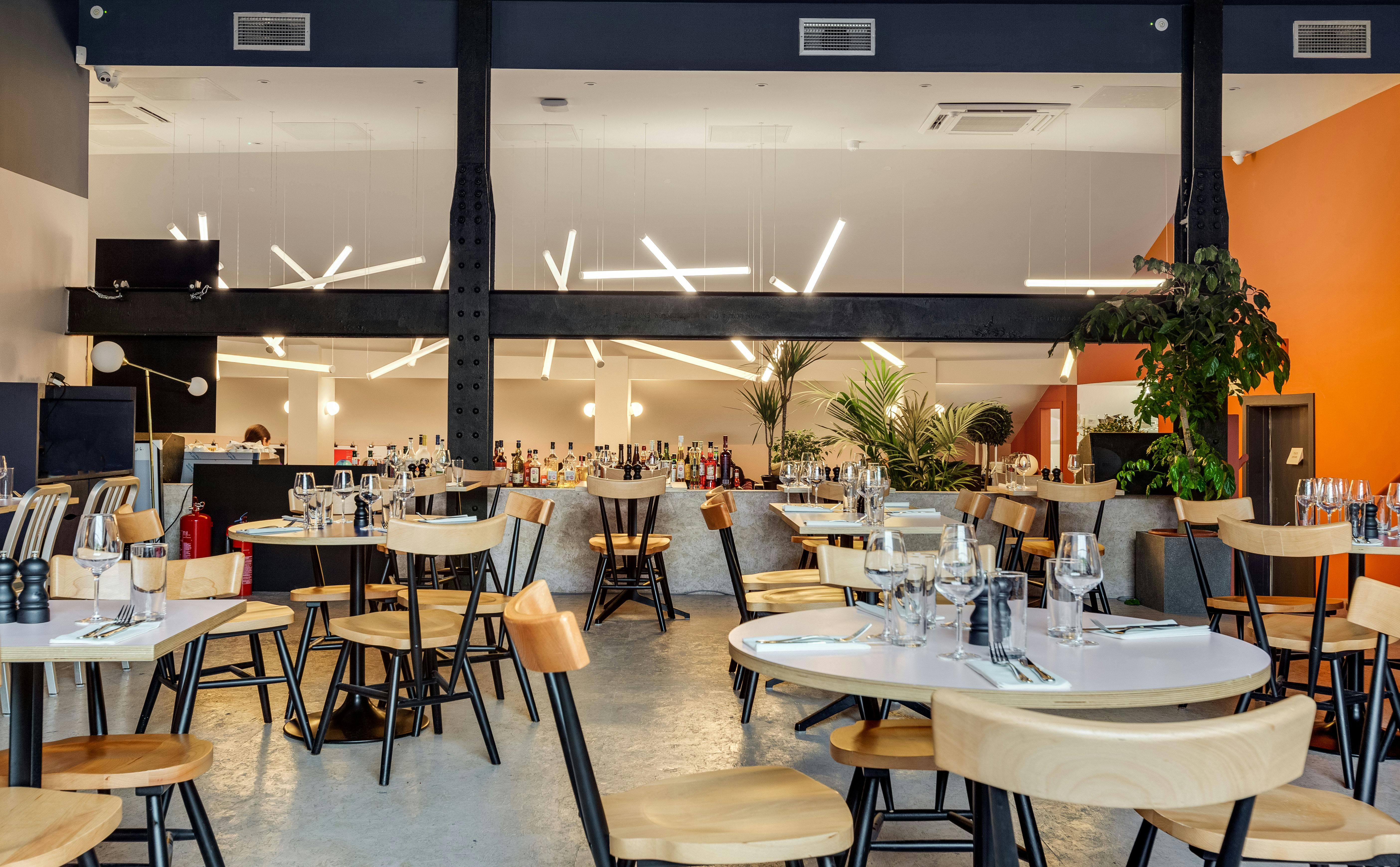 Modern dining space at Bar + Kitchen, ideal for events with stylish decor and ample seating.