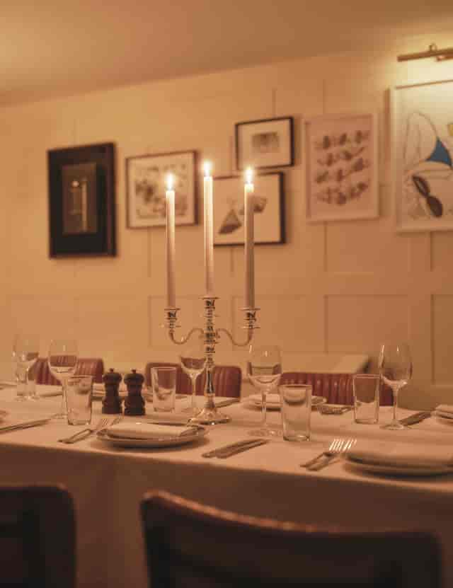 Elegant dining table with candlelight for sophisticated events and intimate dinners.