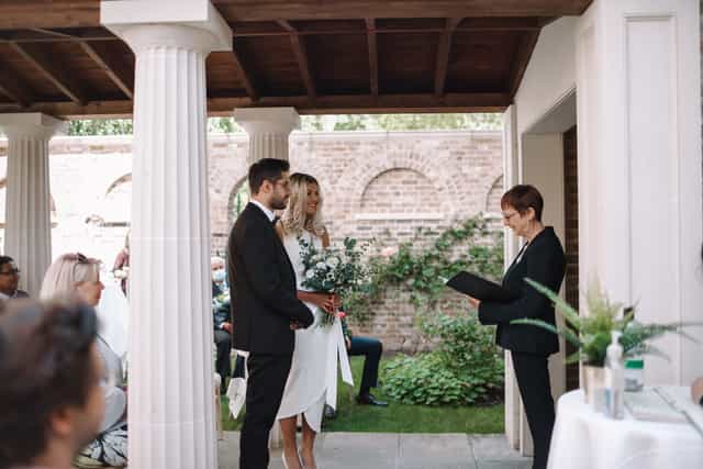 Outdoor wedding ceremony at The Colonnade, Pitzhanger Manor, with elegant columns.