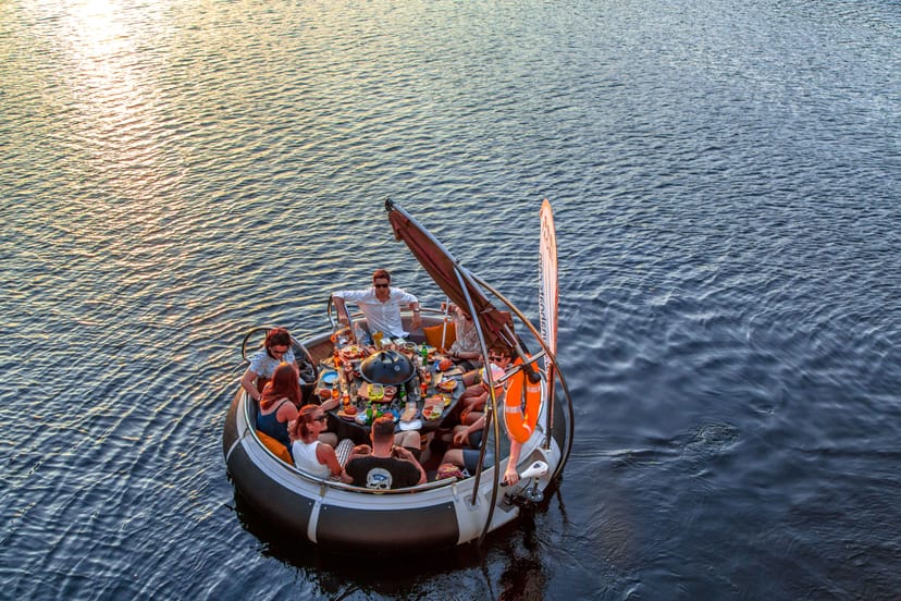 BBQ Boat on water, circular seating for team-building and social events.