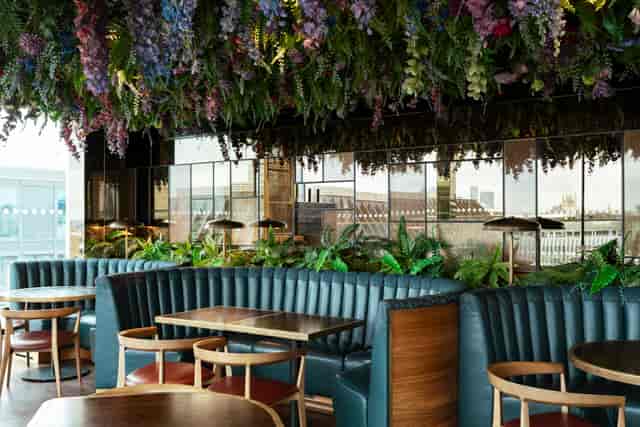Stylish LSQ Rooftop venue with greenery, ideal for networking and social events.