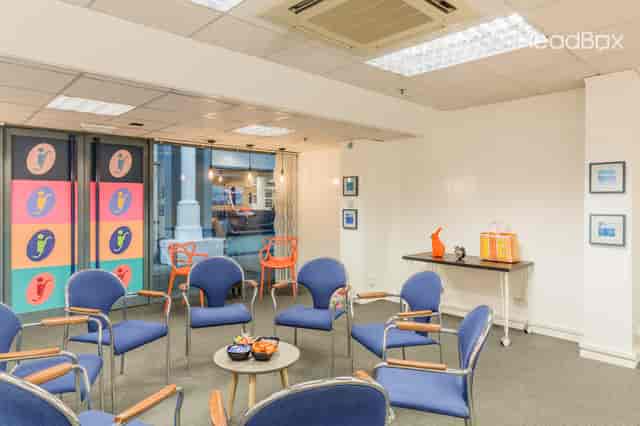 Versatile meeting space in The Cosy Room, colorful decor, perfect for workshops and brainstorming.