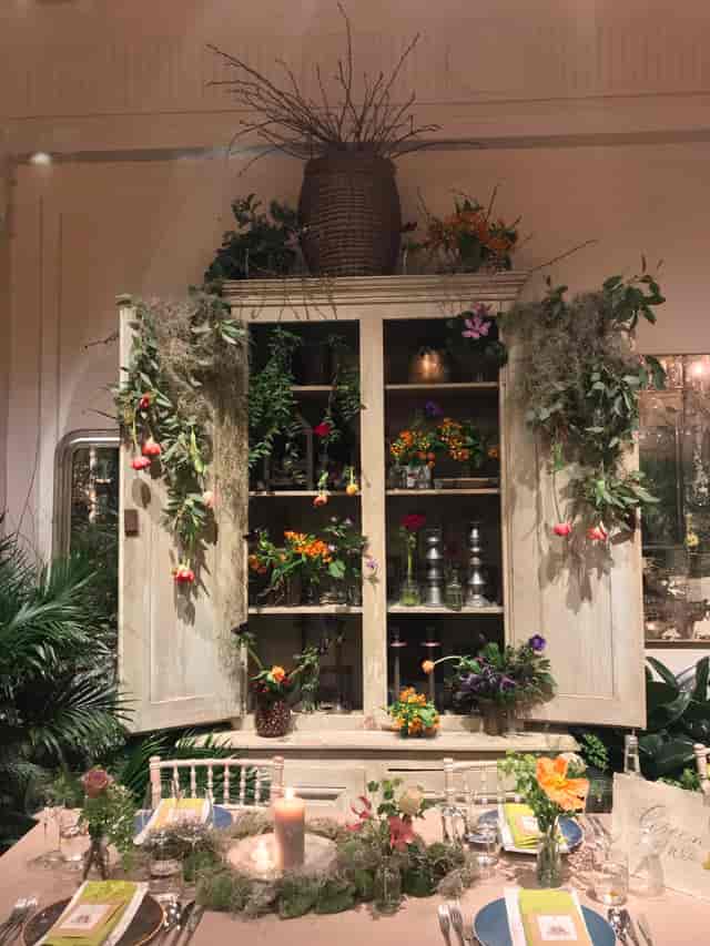 Lush floral display cabinet at Petersham Nurseries for events and gatherings.