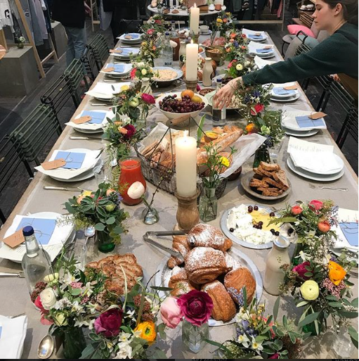 Elegant dining table with floral centerpieces at Petersham Nurseries event.