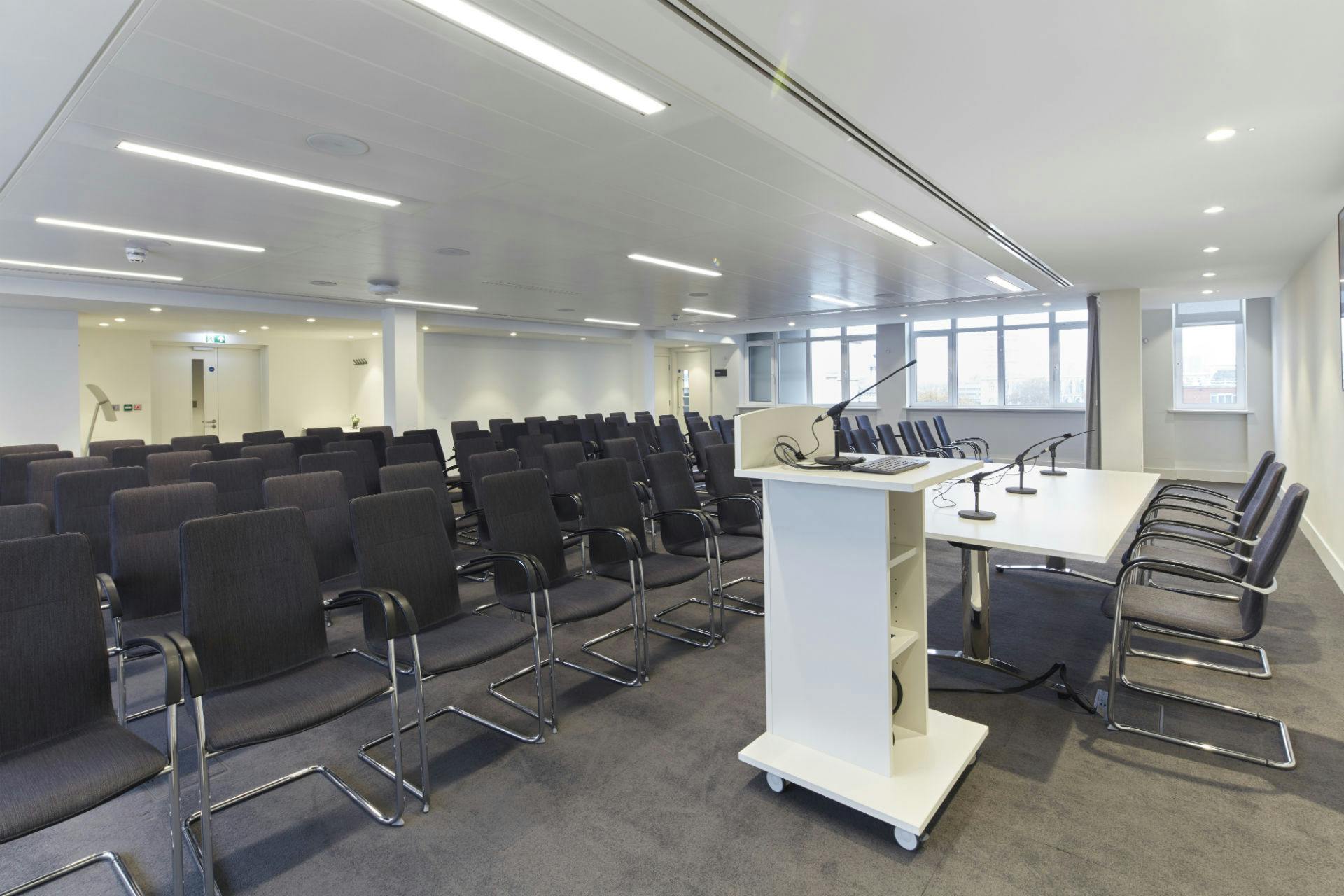 Modern conference room in Westminster with black chairs, ideal for meetings and workshops.