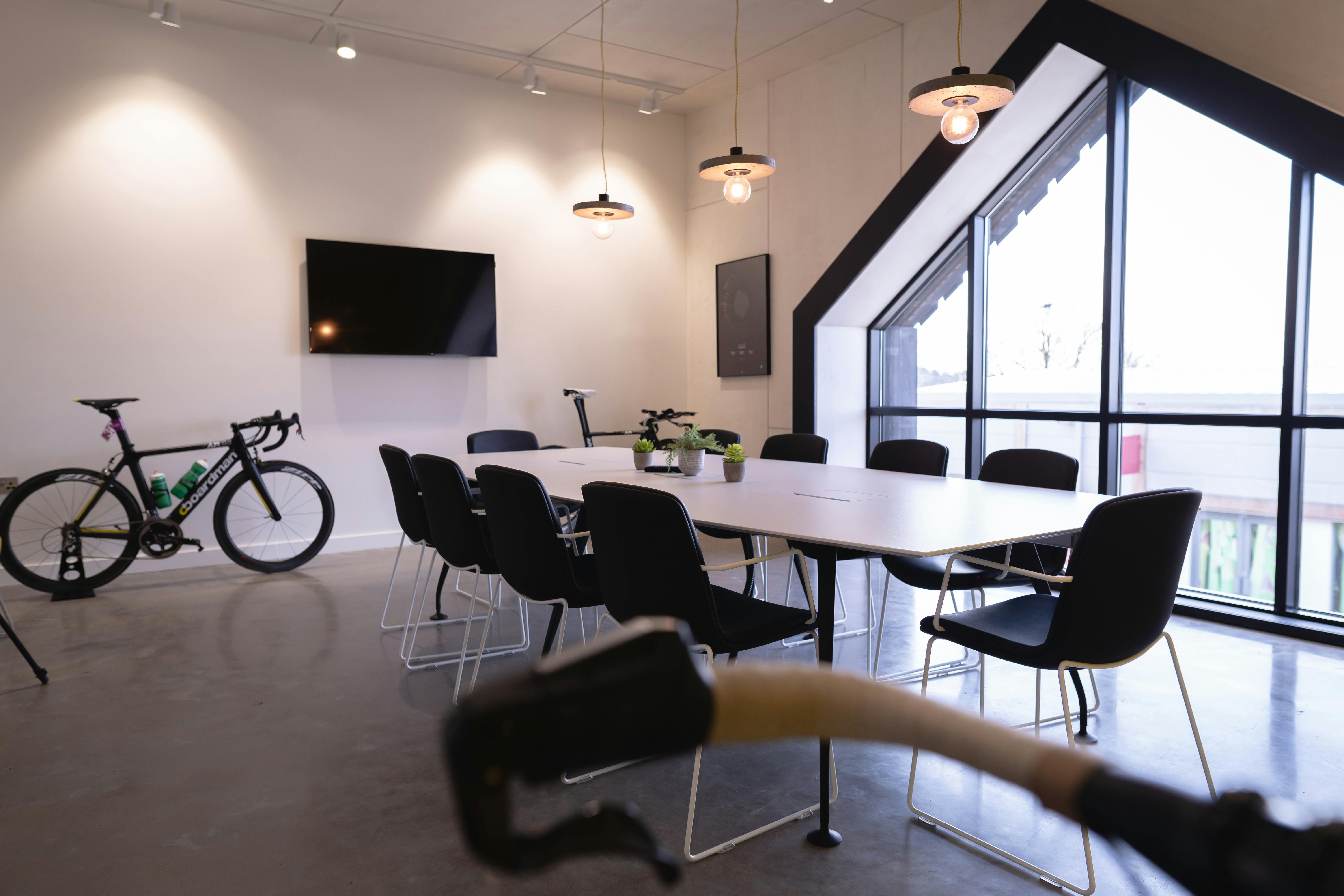 Modern boardroom with long table, ideal for team-building and brainstorming events.