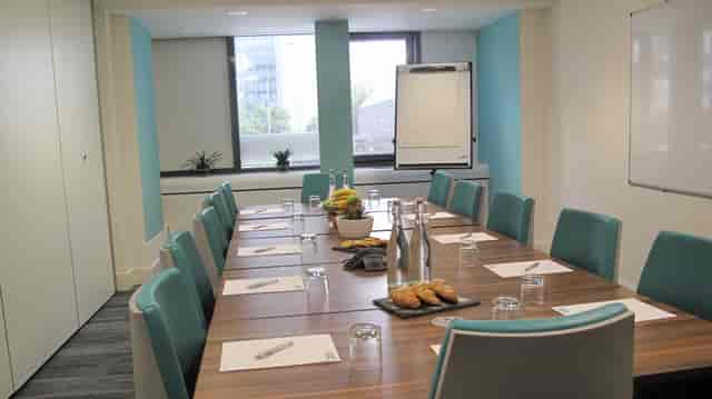 Manor Suite meeting room with long table, ideal for workshops and brainstorming sessions.