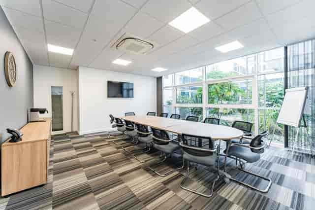 Modern conference room in Baskerville Suite, ideal for meetings and workshops.
