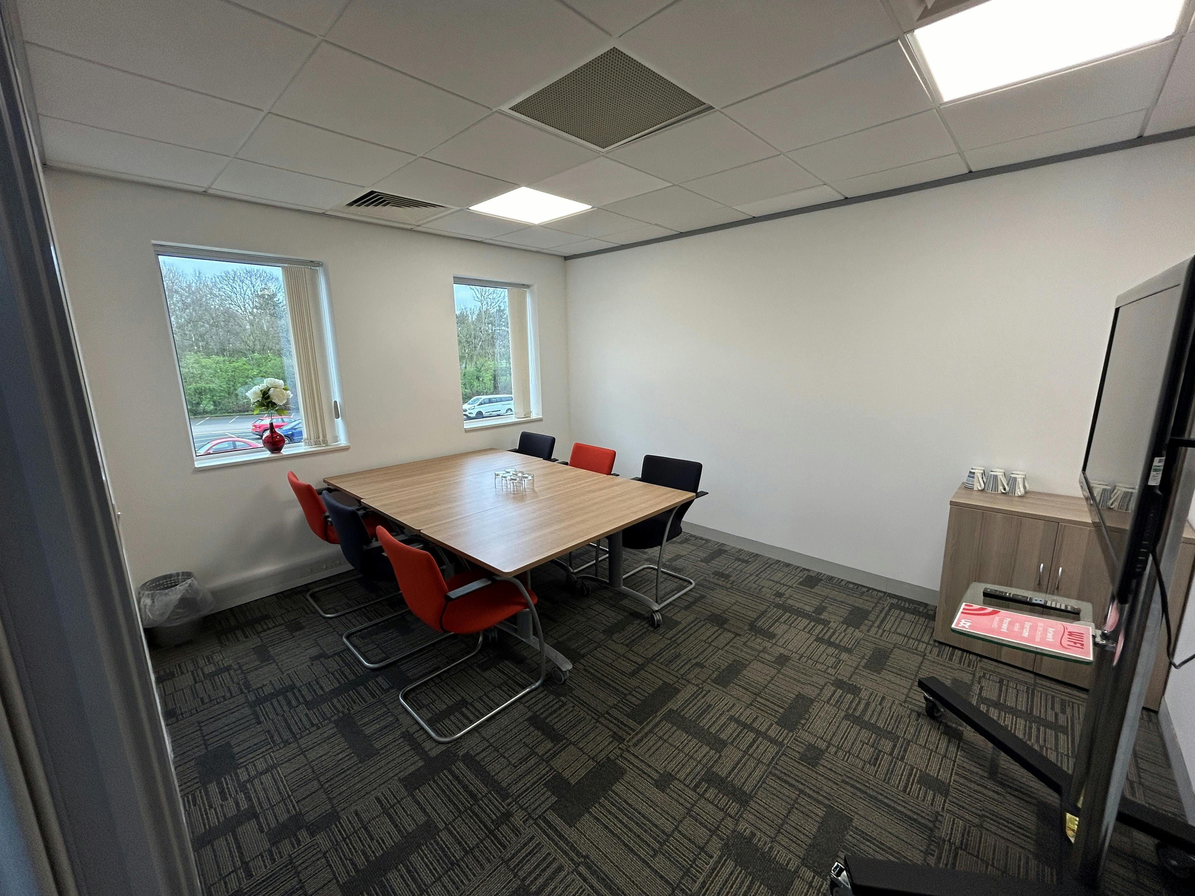 Red Suite at UBC Warrington: modern meeting room with natural light for presentations.