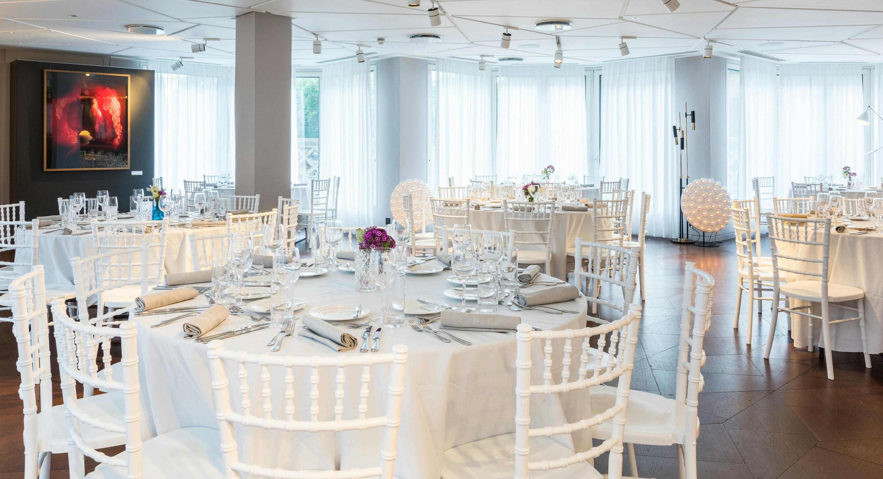 Elegant banquet setting with white chairs at The Lounge, perfect for upscale events.