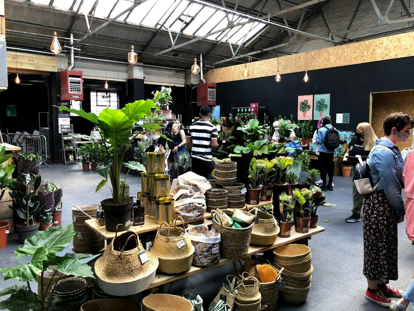 Vibrant indoor market with lush greenery, ideal for eco-friendly events and workshops.