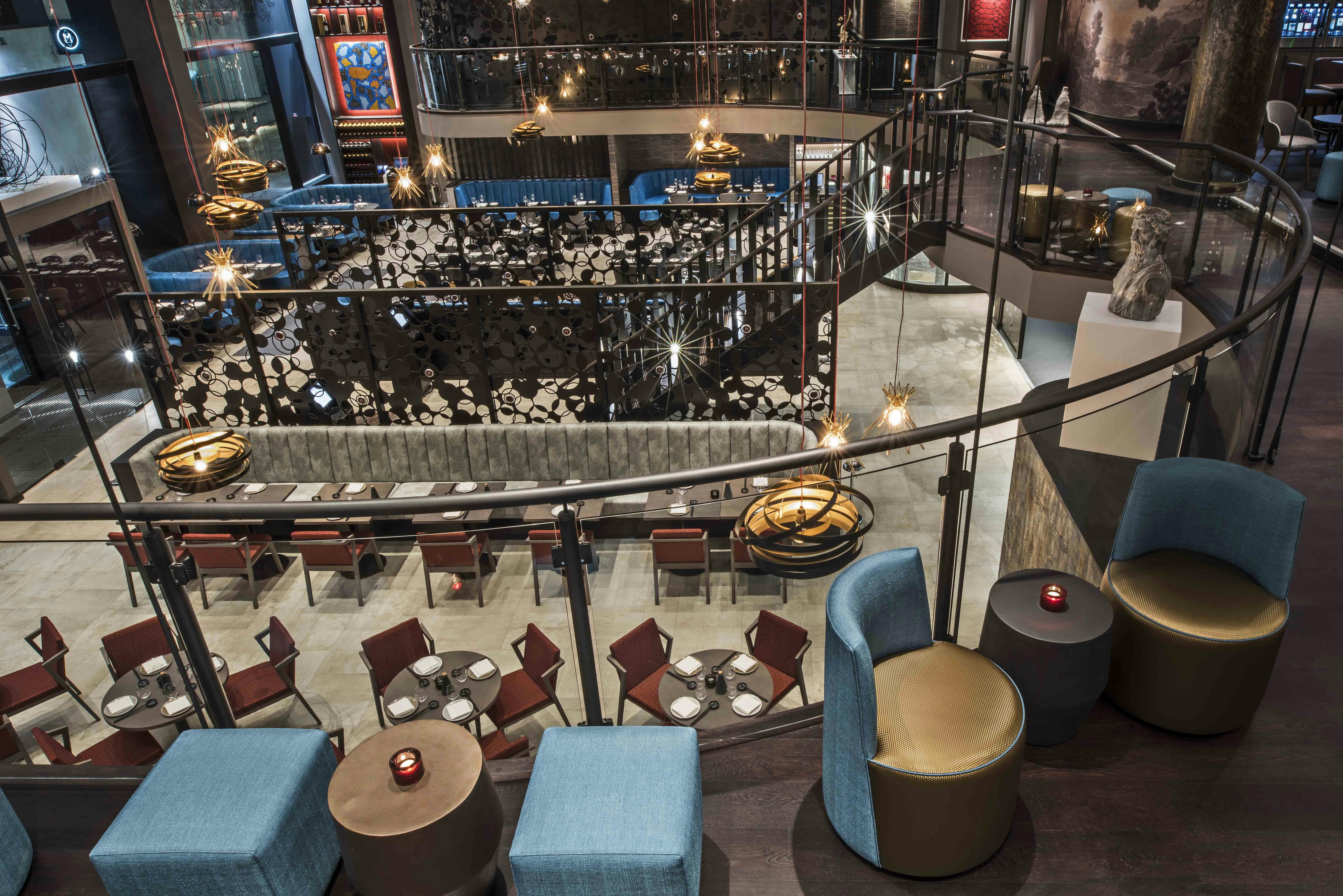Sophisticated multi-level event venue with stylish seating and ambient lighting.