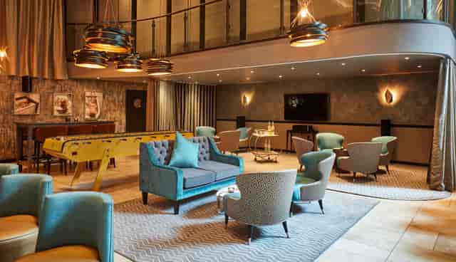 Stylish meeting space at THE DEN, ideal for networking and events with elegant decor.