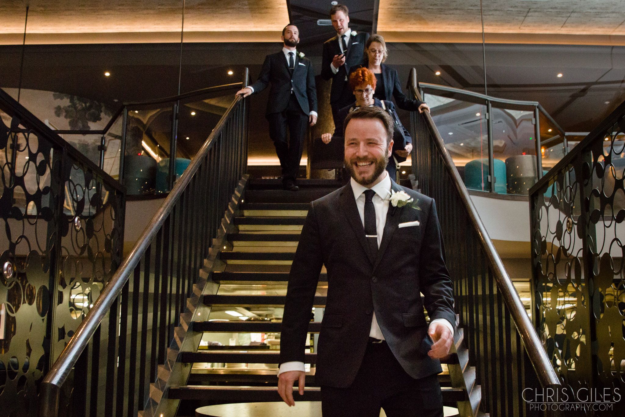 Stylish wedding entrance at M BAR with well-dressed groomsmen and modern decor. - Banner