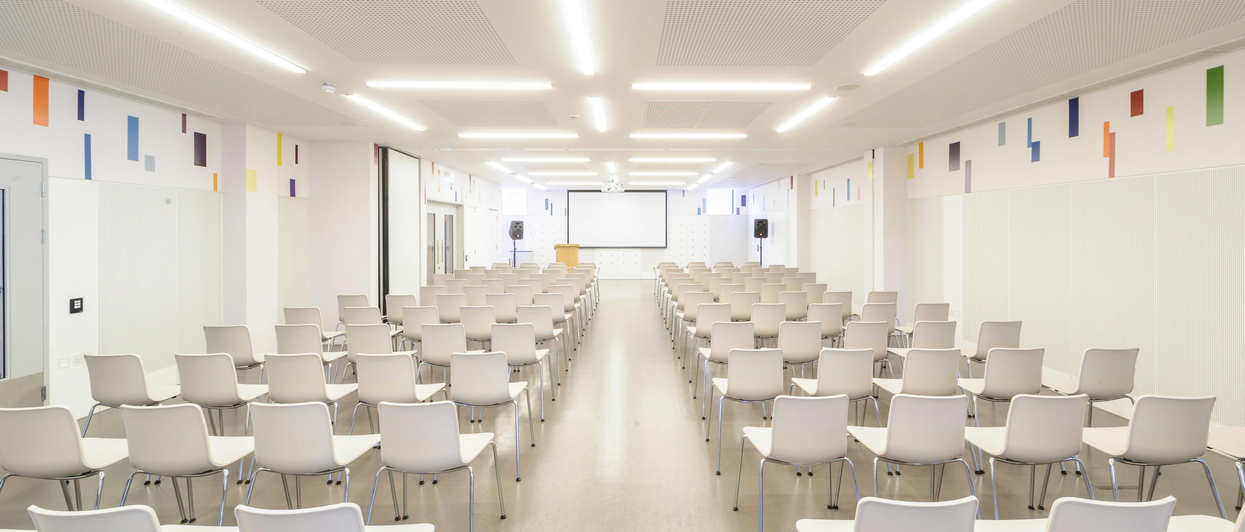 Foyle Centre event space with white chairs for presentations and seminars.