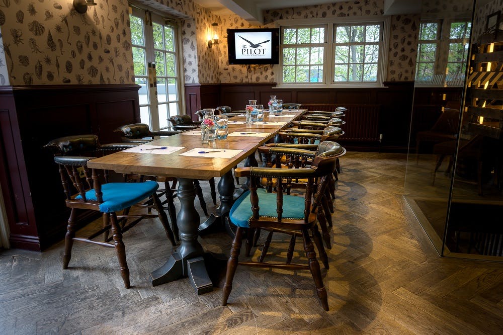 Meeting space at The Bridge in Greenwich with a long wooden table, ideal for workshops.