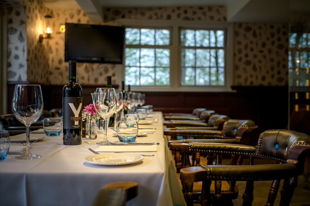 Elegant dining table at The Bridge, perfect for meetings and events with floral accents.