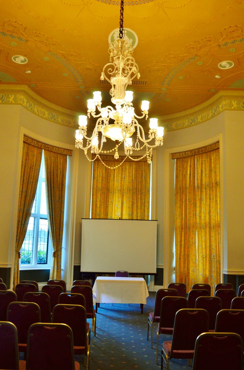 Elegant Georgian Room at Broome Park Hotel with chandelier, perfect for meetings and workshops. - Banner