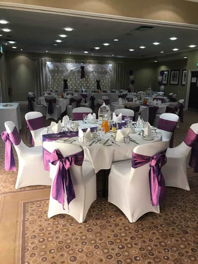 William Duesbury at elegant wedding event with purple accents and sophisticated decor.
