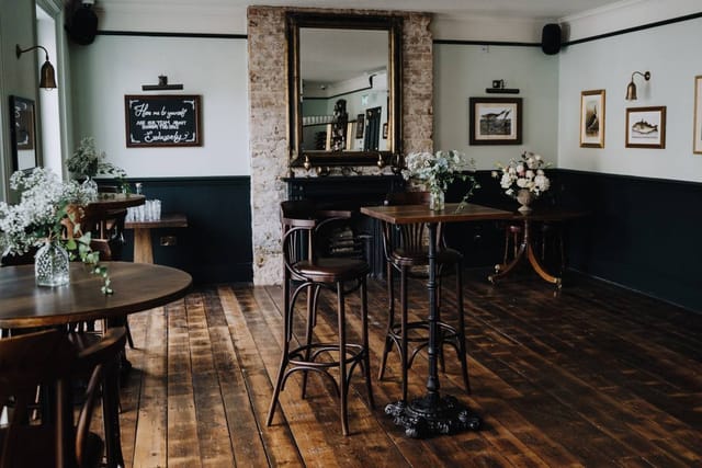 Stylish event space with rustic floors, perfect for networking and intimate gatherings.
