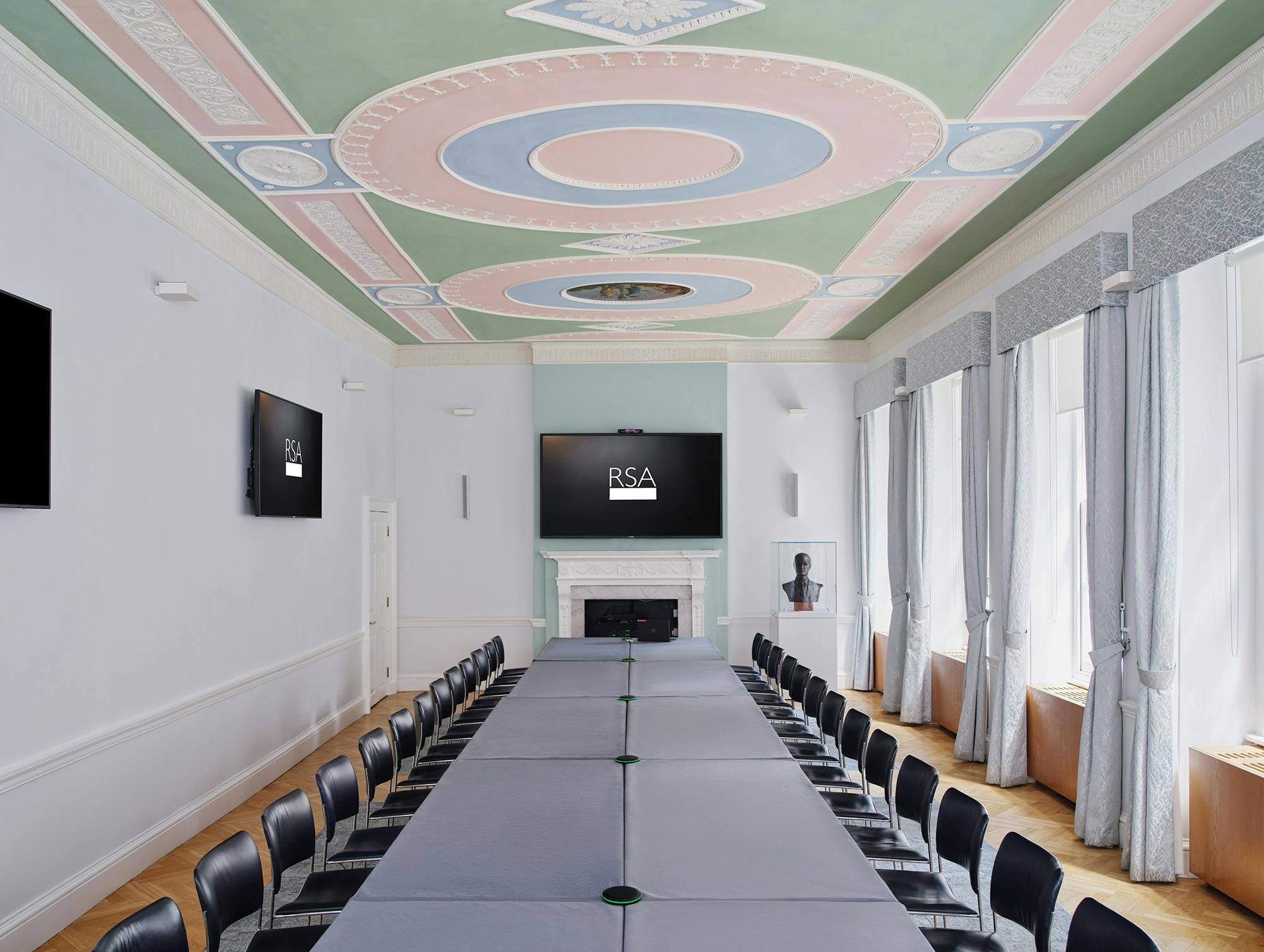 Elegant meeting room with sophisticated ceiling, ideal for professional gatherings and brainstorming.