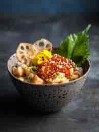 Sushi dish with edible flowers at The Rambutan Room, perfect for upscale events catering.