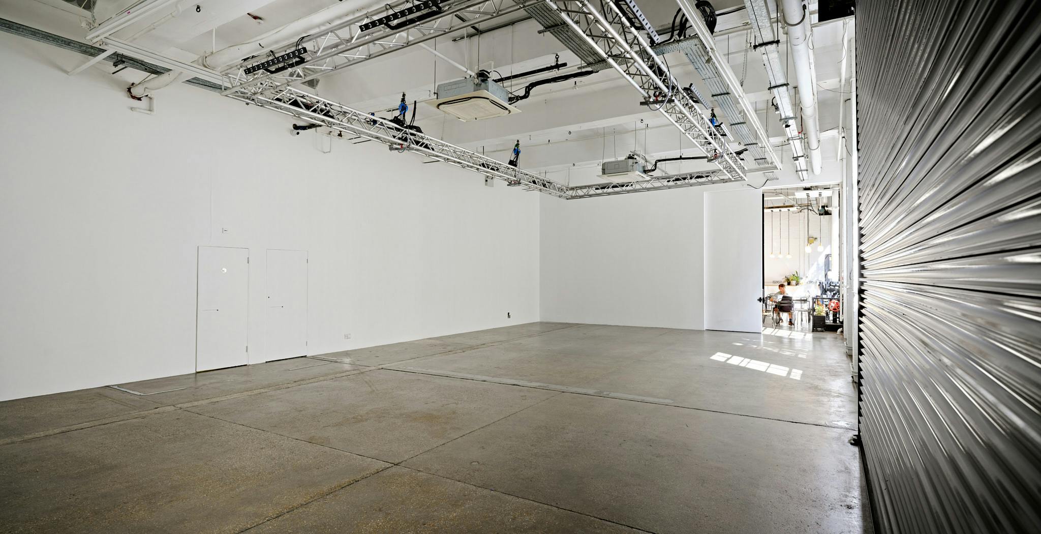 Versatile event space with high ceilings and natural light for corporate meetings or workshops.