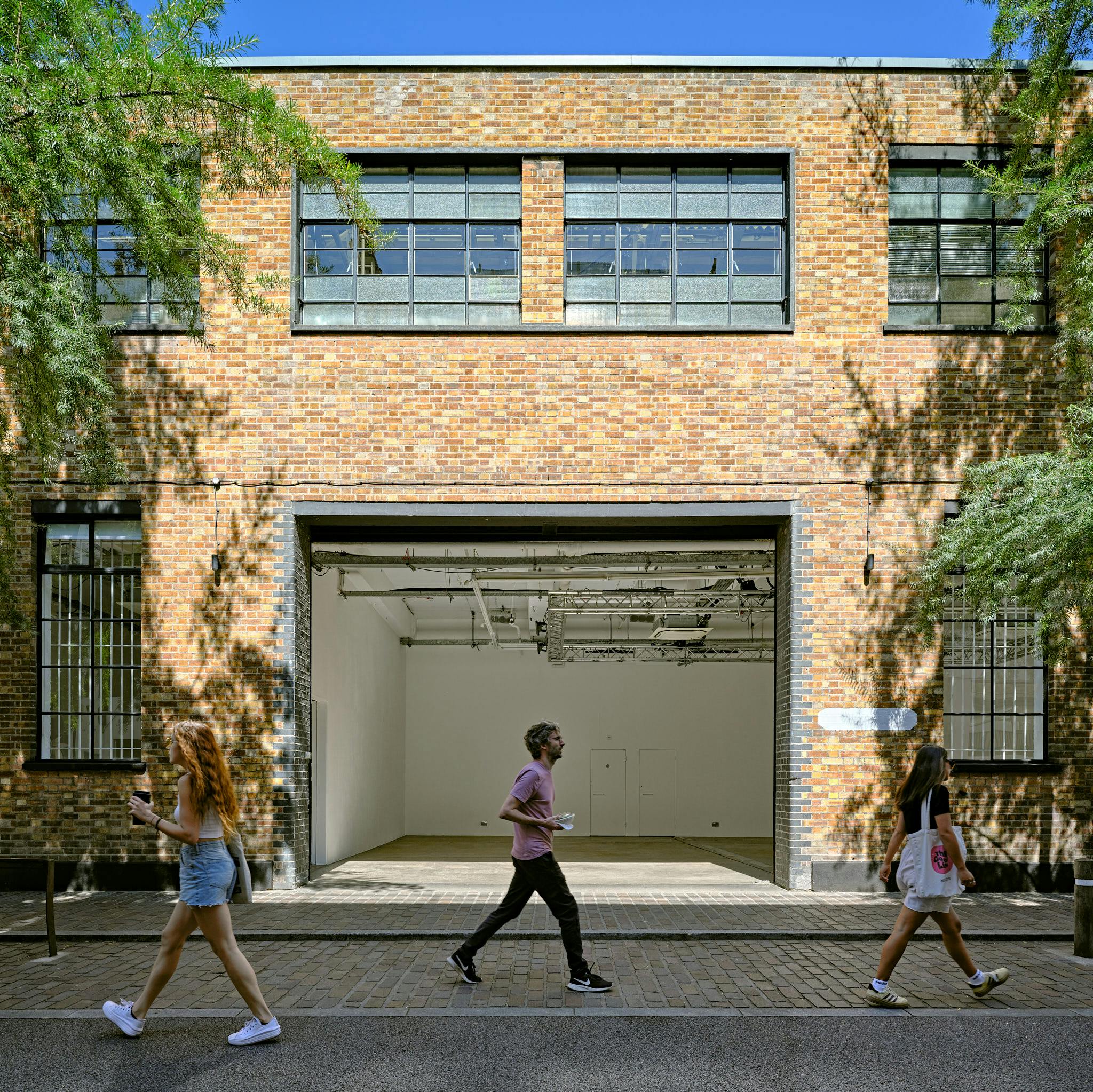 Versatile event space with large windows in Protein Studios, perfect for creative meetings.