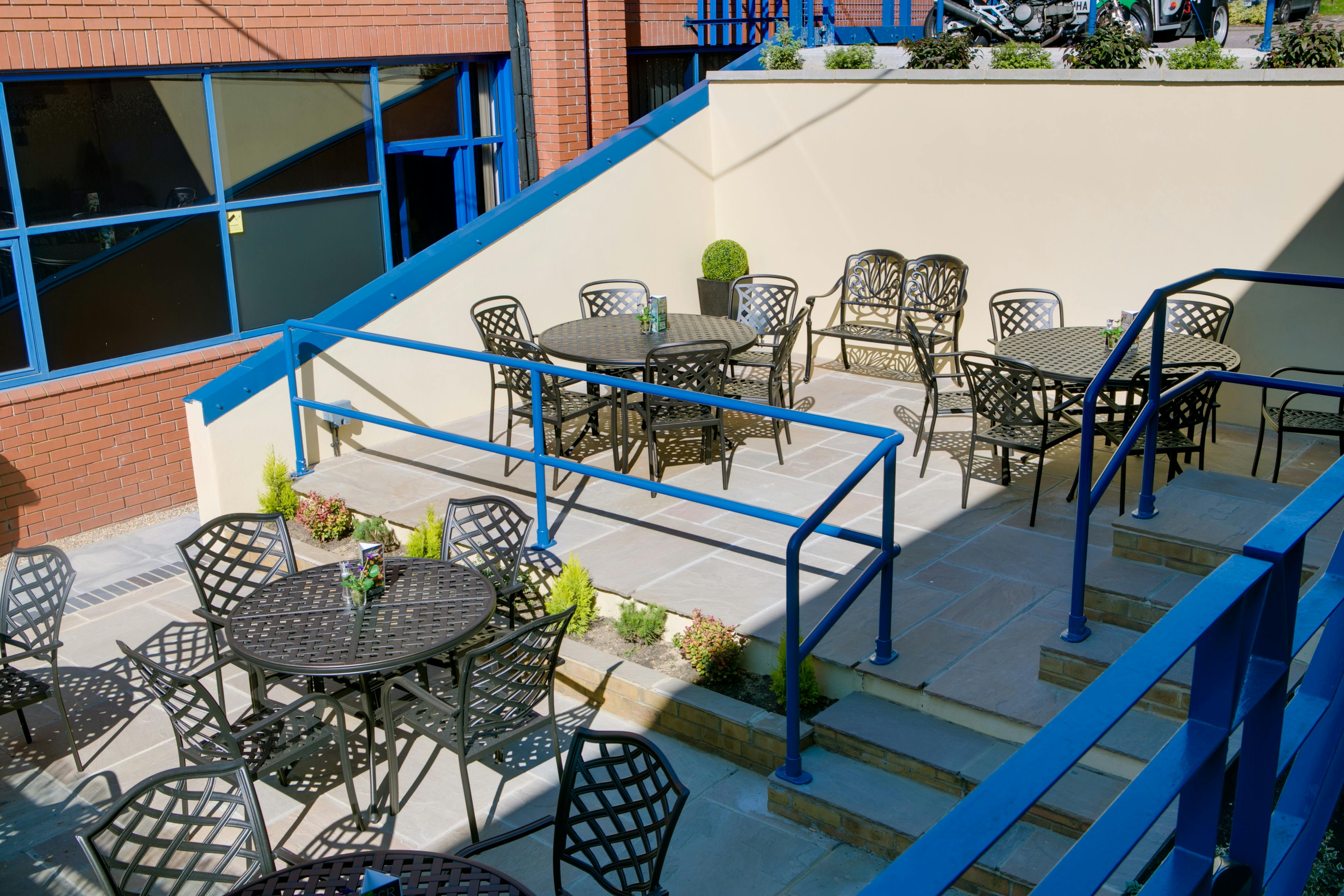 "King Charles Theatre outdoor event space with tables for networking and conferences."