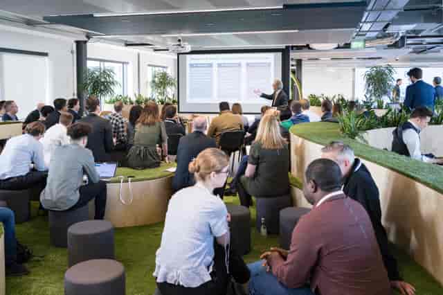 Modern collaborative meeting space in London with digital displays for workshops.