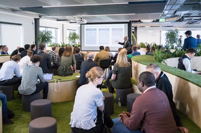 Modern collaborative meeting space in London with digital displays for workshops.