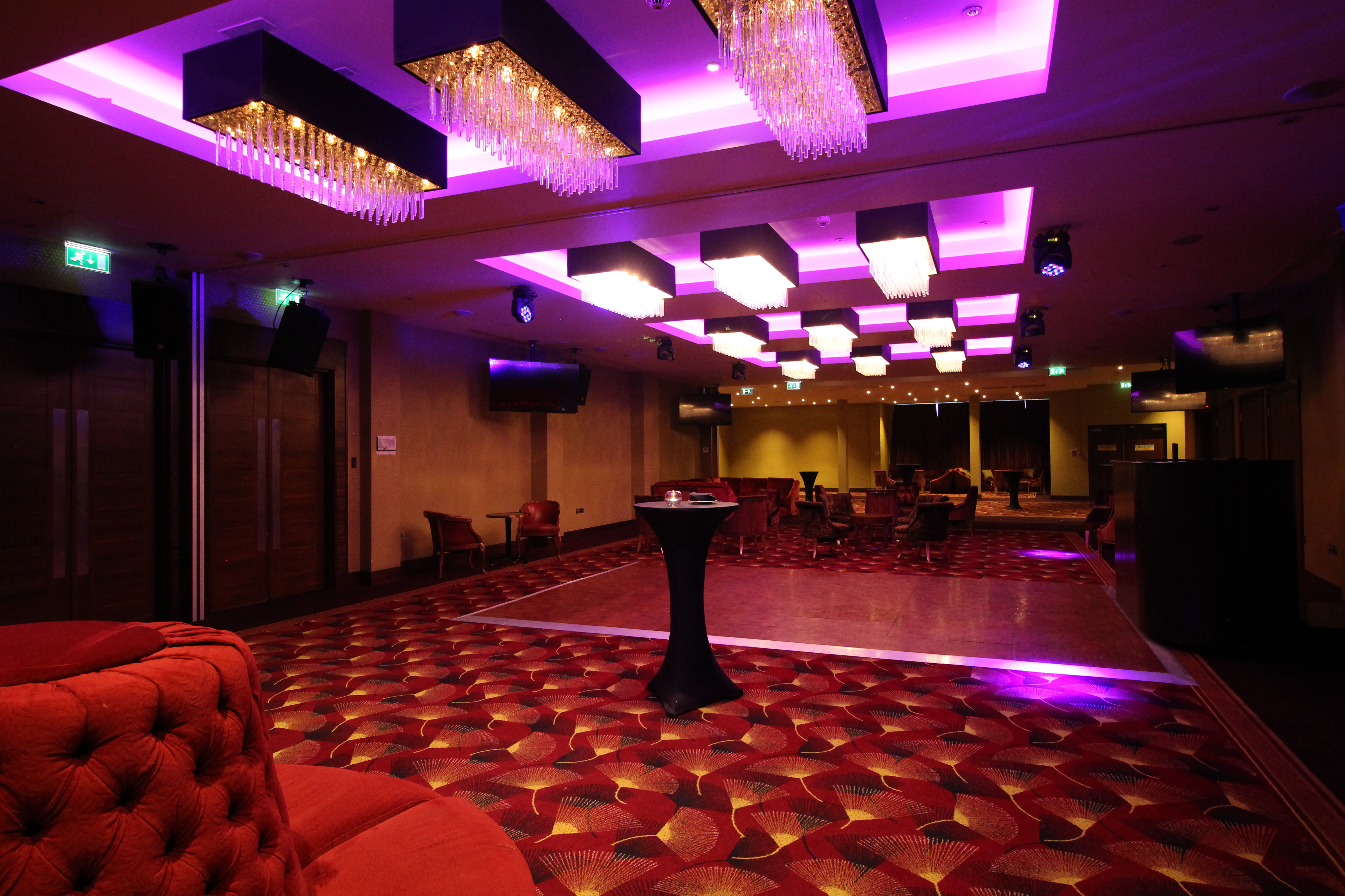 Elegant wedding venue at Holiday Inn Kensington with modern decor and vibrant purple hues. - Banner