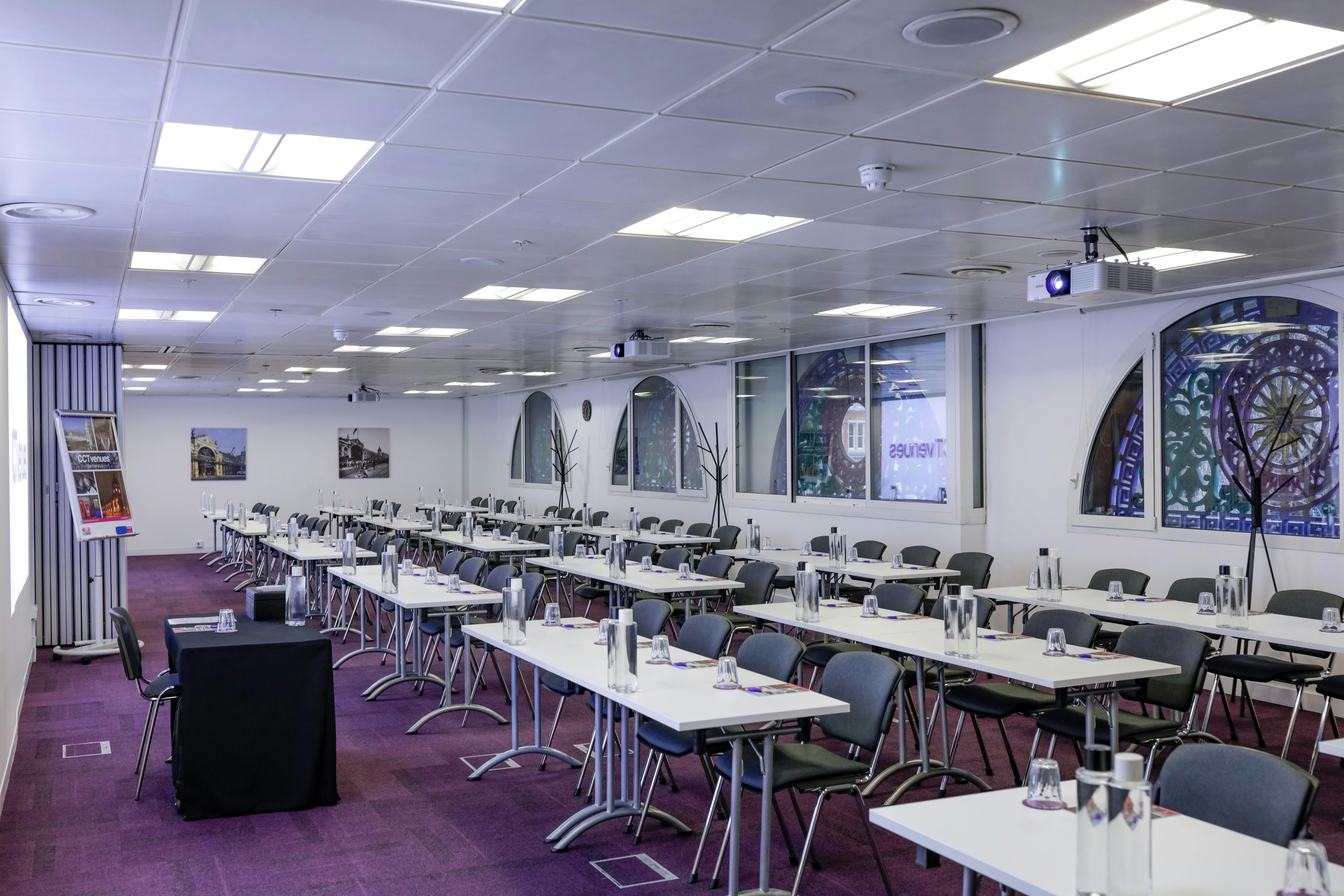 Smithfield Suite meeting room with stained glass windows for professional events.