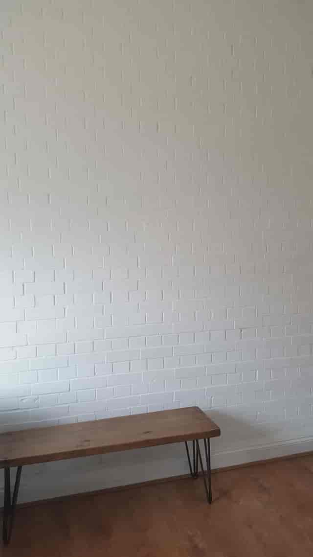 Clean white brick wall at Marcophysio Westferry, perfect for minimalist event backdrops.