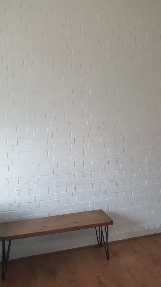Clean white brick wall at Marcophysio Westferry, perfect for minimalist event backdrops.