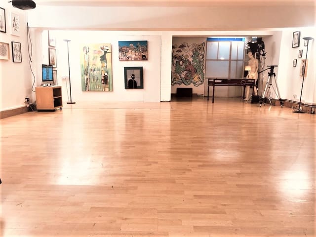 Spacious Dalston Den venue with polished wooden floors for events and exhibitions.
